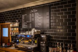 a coffee shop with a menu on the wall at The Castle Hotel, Conwy, North Wales - The Coaching Inn Group in Conwy