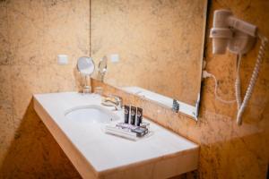 a bathroom with a sink and a mirror at Casa Amarela TH & National Monument in Castelo de Vide +36 photos