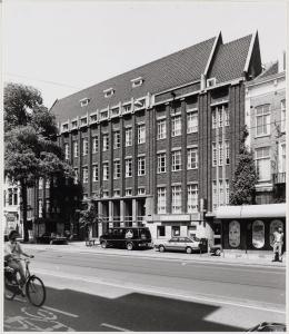 a person riding a bike in front of a building at B&B midtown Amsterdam in Amsterdam