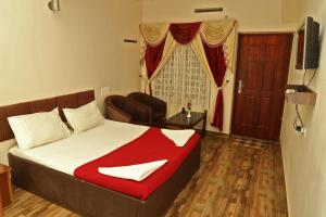 Ένα ή περισσότερα κρεβάτια σε δωμάτιο στο Velu's Resort