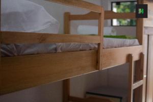 a bunk bed in a room with a ladder to the top bunk at Helecho's Hostal in Encarnación