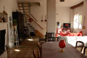 a living room with a table and a staircase at Les Demeures de la Laigne in Allas-Bocage
