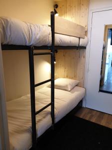 2 Etagenbetten in einem Zimmer mit Spiegel in der Unterkunft Pra Loup Appart'hotel in Pra-Loup