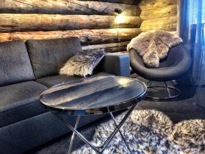 a living room with a couch and two chairs and a table at Ruka Chalet Charmant Oliver in Ruka +29 photos
