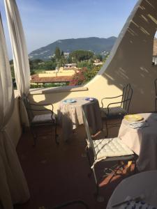 two tables and chairs on a balcony with a view at Nel Sole di Daniel in San Felice Circeo