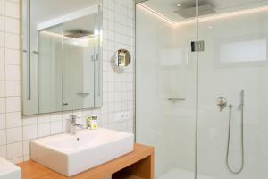a bathroom with a sink and a shower at Vanilla Garden Boutique Hotel - Adults Only in Playa de las Americas