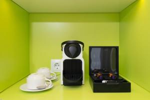 a black and white coffee maker next to a tv at Vanilla Garden Boutique Hotel - Adults Only in Playa de las Americas