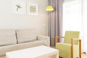 a living room with a couch and a chair at Vanilla Garden Boutique Hotel - Adults Only in Playa de las Americas