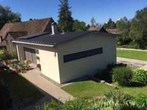 a white garage with a black roof at Appartement Elisa in Hörbranz