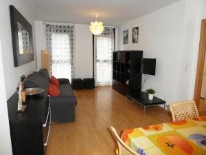 a living room with a couch and a table at Apartamentos 3000 Jaca in Jaca