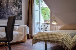 a bedroom with a bed and a large window at Villa Antumalal B&B in Málaga