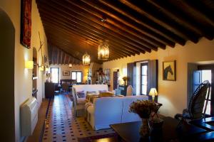 a living room with white couches and a table at Hacienda de Santa Teresa in Almonte