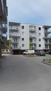 a parking lot in front of a large building at Nadmorski Szept in Dziwnówek
