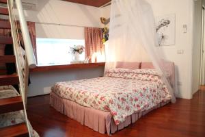 a bedroom with a bed with a canopy at a casa di Marzia in Reggio Emilia