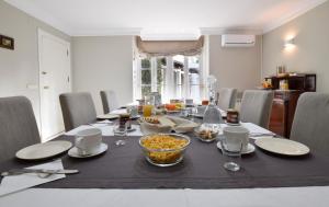 a table with a bowl of food on it at Villa Antumalal B&B in Málaga
