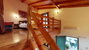 a wooden staircase in a room with a bedroom at Nana Apartments in Zarós