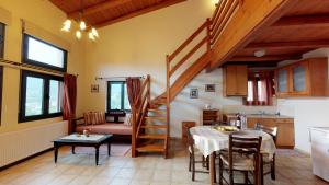 a living room with a table and a staircase at Nana Apartments in Zaros