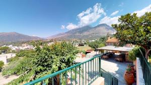 a balcony of a house with mountains in the background at Nana Apartments in Zarós