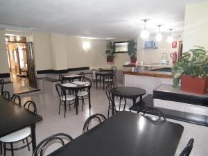 a restaurant with tables and chairs and a counter at Hostal La Muralla in Morella +7 photos