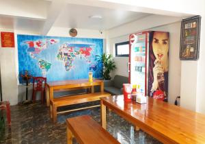 a room with a table and a map on the wall at Long Hotel and motobike rental in Ha Giang