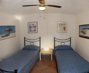A bed or beds in a room at Residence Cala Chiesa