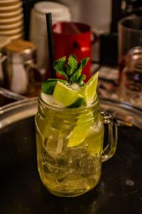 a mason jar of lemonade with lime and a garnishment at The Castle Hotel, Conwy, North Wales - The Coaching Inn Group in Conwy