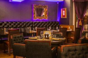 a dining room with a table and chairs at The Castle Hotel, Conwy, North Wales - The Coaching Inn Group in Conwy
