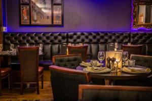 a dining room with a table and chairs at The Castle Hotel, Conwy, North Wales - The Coaching Inn Group in Conwy