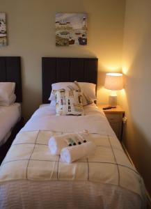 a bedroom with a bed with two towels on it at The Captains Cottage, Cushendall in Cushendall