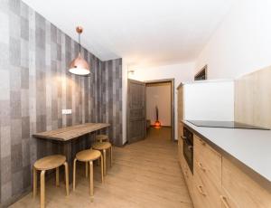 a kitchen with a table and stools and a counter at L-DOM in Metzingen