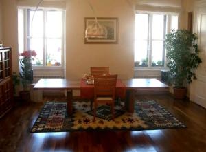 a dining room with a table and chairs and windows at AL PONTEROSSO in Trieste