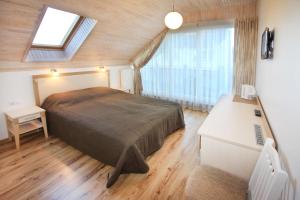 a bedroom with a large bed in a room at Vila Domino in Palanga