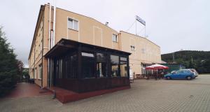 a building with a car parked in front of it at Hotel Adria in Rumia