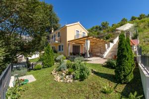 a house with a garden in front of it at HIDDEN PARADISE - Villa by Split in Žrnovnica