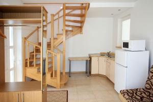 a kitchen with a spiral staircase in a small room at Vila Domino in Palanga