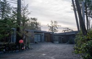 a house in the middle of a forest at Storm Cove Suites in Ucluelet