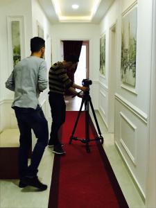 
two people standing in a room with a door open at Vila Ada Hotel in Tirana
