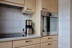a kitchen with a coffee maker on a counter at Haus Finisberg in Flensburg