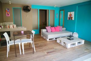 a living room with a couch and a table and a dining room at Meno Suites in Gili Meno +23 photos