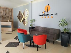 a waiting room with a couch and colorful chairs at Atva Residence Hotel in Dolni Dobrenoec