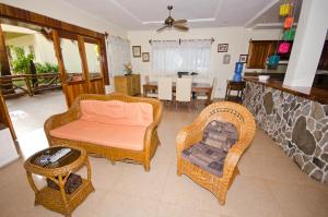 a living room with wicker chairs and a table at Mike's Dauin Dive Resort in Dauin