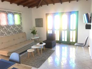 a living room with a couch and a table and chairs at La Martinera Parque Central in Guatapé