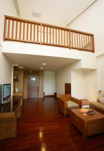 a living room with a staircase and a couch at Luminous Hot Spring Resort & SPA in Luye