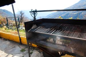 a grill with a bird sitting on top of it at "Casa ibero" Bubion in Bubión