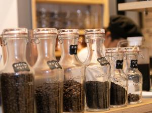 four glass bottles filled with seeds on a table at APA Hotel Shin Osaka Ekiminami in Osaka