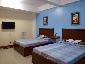 Letto o letti in una camera di Mayon Lodging House