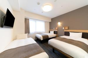 Postel nebo postele na pokoji v ubytování Pearl Hotel Shinjuku Akebonobashi