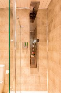 a shower with a glass door in a bathroom at Clyde View Apartment in Helensburgh
