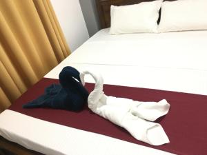 a pair of white socks and underwear on a bed at Hotel Lovusiyah in Jaffna