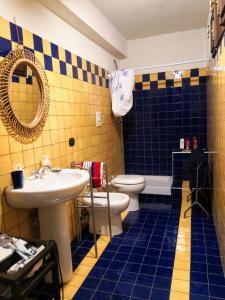 a bathroom with a sink and a toilet and a mirror at La tana del riccio in San Sisto dei Valdesi